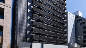A modern hotel building with multiple floors, large windows, and a prominent 'HOTEL' sign. - Comfort Hotel Shin-Osaka (Osaka)