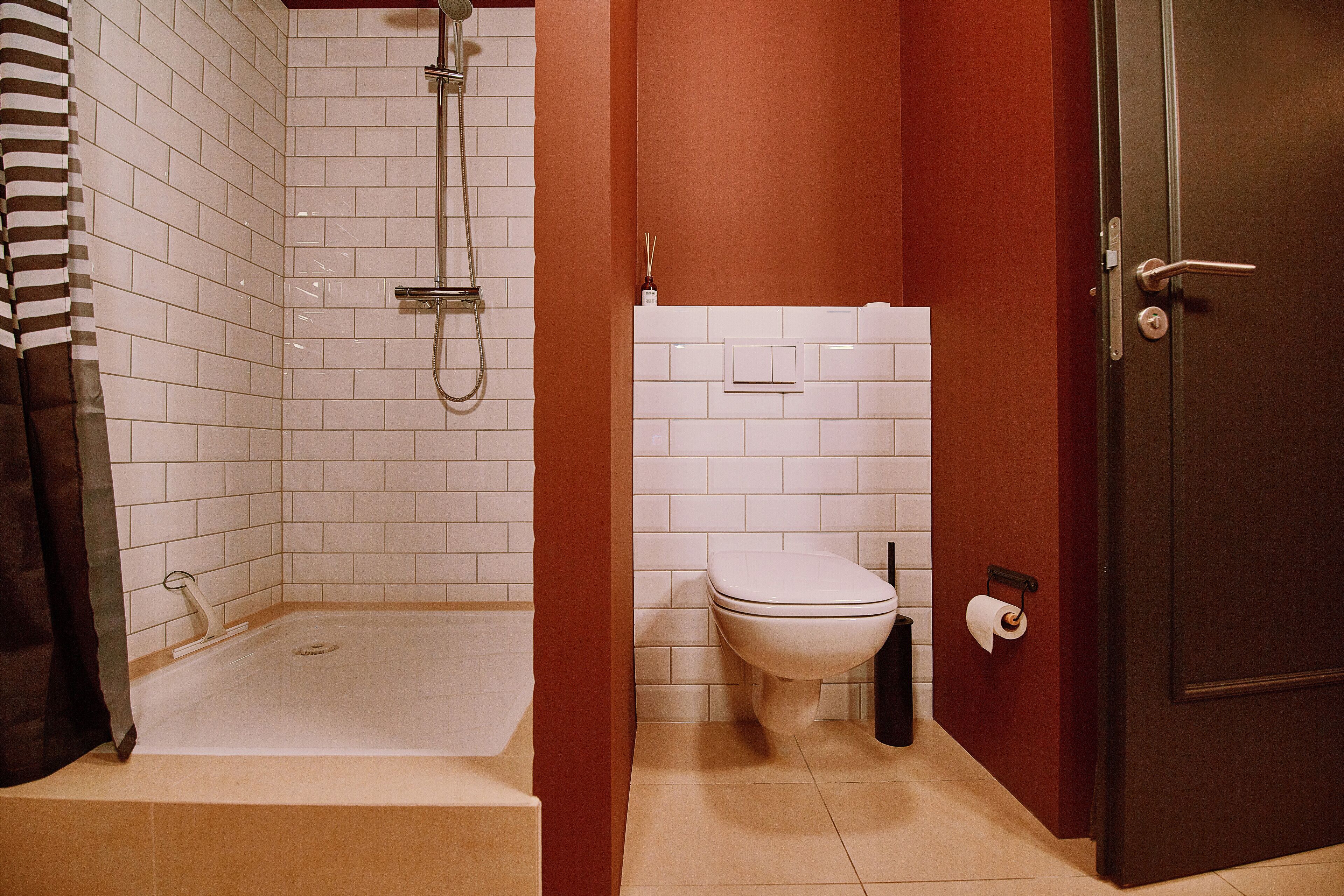 A bathroom with a bathtub, toilet, and shower.