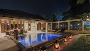 A swimming pool with a patio area, outdoor furniture, and decorative lanterns. - The Villa - Luxury Private Pool Villa (Langkawi)