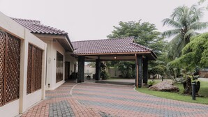 A covered walkway leading to a building with a tiled roof and a patterned brick pathway. - The Villa - Luxury Private Pool Villa (Langkawi)