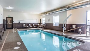 A swimming pool with a tiled edge, a lifeguard chair, and a sunshade. - Sleep Inn & Suites Mt. Hope near Auction & Event Center (Mount Hope)