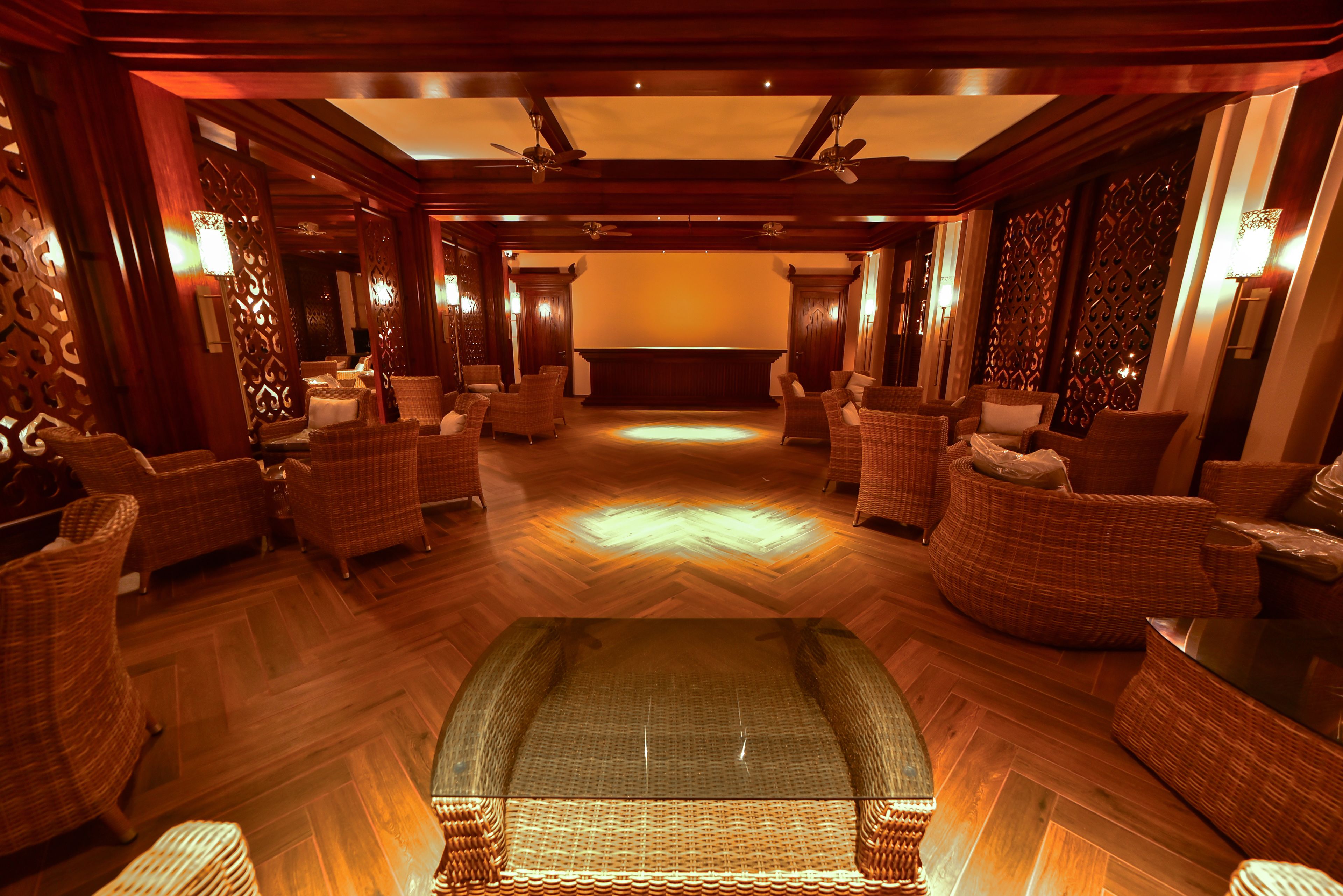A spacious lobby with a central seating area, high ceilings, and decorative wall panels.