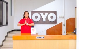 Un comptoir d’accueil avec une enseigne indiquant « OYO » et une étiquette « RÉCEPTION ».