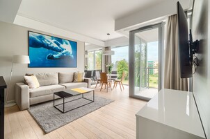 Deluxe Apartment, 1 Bedroom, Partial Sea View | Living area | Flat-screen TV