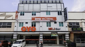 A hotel named OYO Mr. J Hotel with a prominent sign and a parking area in front. - OYO 718 MR J Hotel Wakaf Che Yeh 1 (Kota Bharu)
