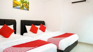 A hotel room with two beds, each with white bedding and red accents, a painting on the wall, and an air conditioning unit. - OYO 718 MR J Hotel Wakaf Che Yeh 1 (Kota Bharu)