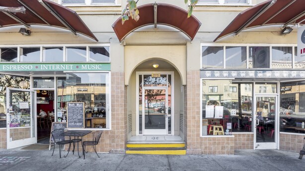 A storefront with a sign reading "ESPRESSO INTERNET MUSIC" and a door labeled "POSTER". - Cosy Berkeley Apartments Just Across UC Berkeley #206 (Berkeley)
