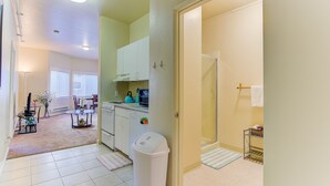 A compact living space with a kitchenette, dining area, and a bathroom. - Cosy Berkeley Apartments Across UC Berkeley #121 (Berkeley)