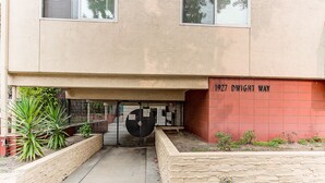 A building entrance with a sign reading "1927 DWIGHT WAY."