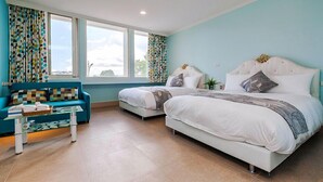A bedroom with two beds, a sofa, and a window with curtains.
