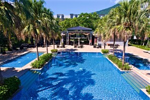A pool area with two separate swimming pools, lounge chairs, and a gazebo. - Gaeavilla Resort (Ji'an)