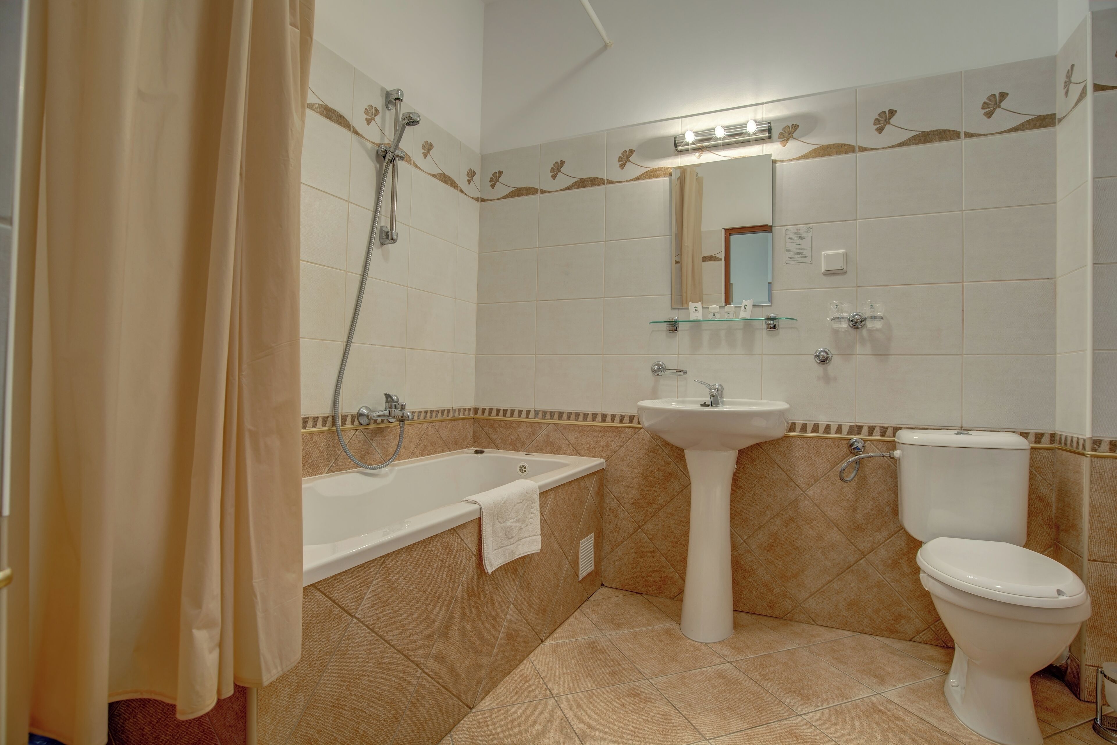 A bathroom with a bathtub, sink, and toilet.