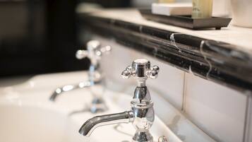 A bathroom with a black countertop and a white sink.