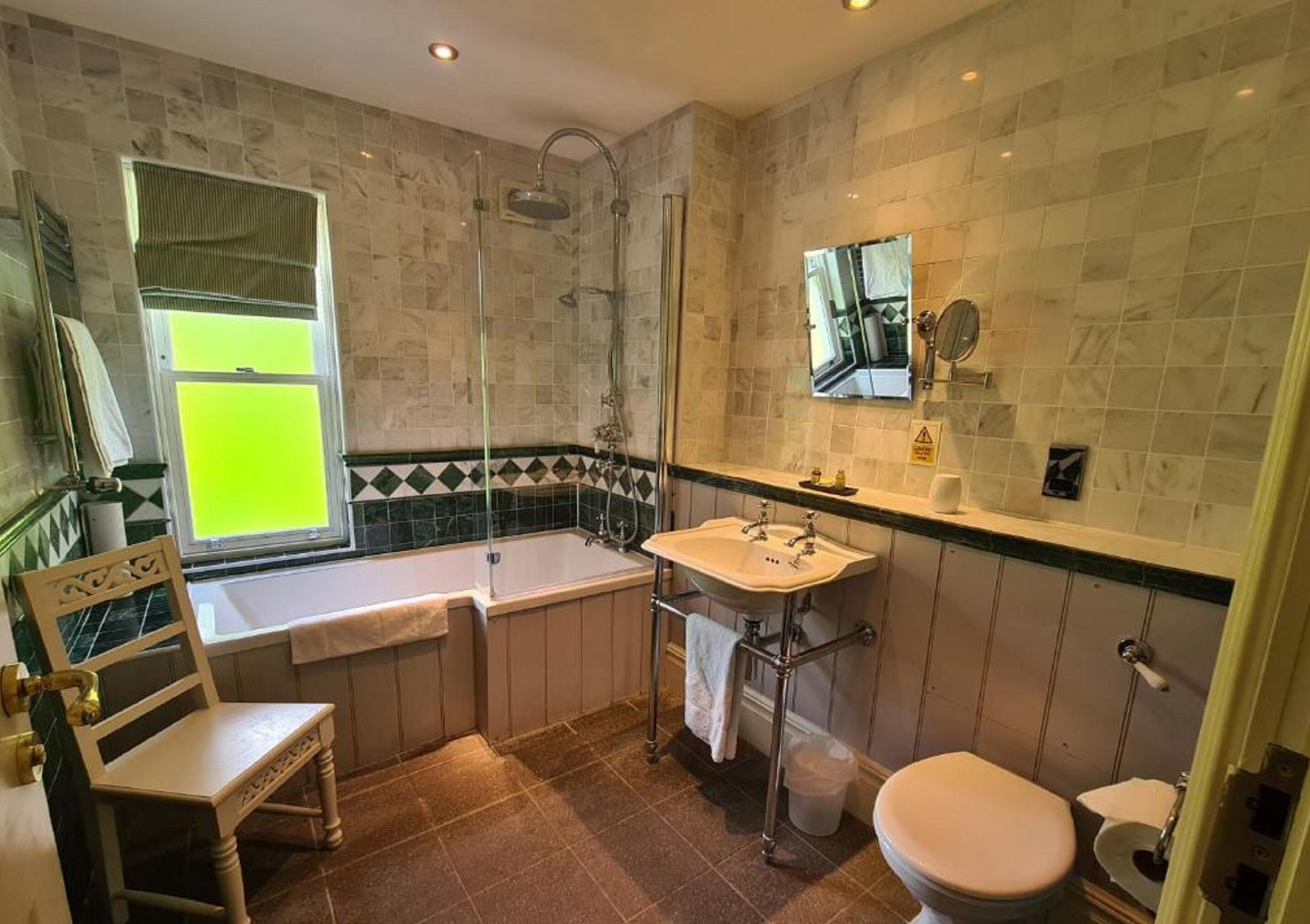 A bathroom with a bathtub, a sink, a toilet, and a shower.