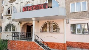 A building with a sign reading "HOTEL" and a staircase leading to an entrance. - FM Hostel Almaty (Almaty)