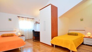 A bedroom with two beds, a desk, and a wardrobe. - Villa Marina Betina (Tisno)