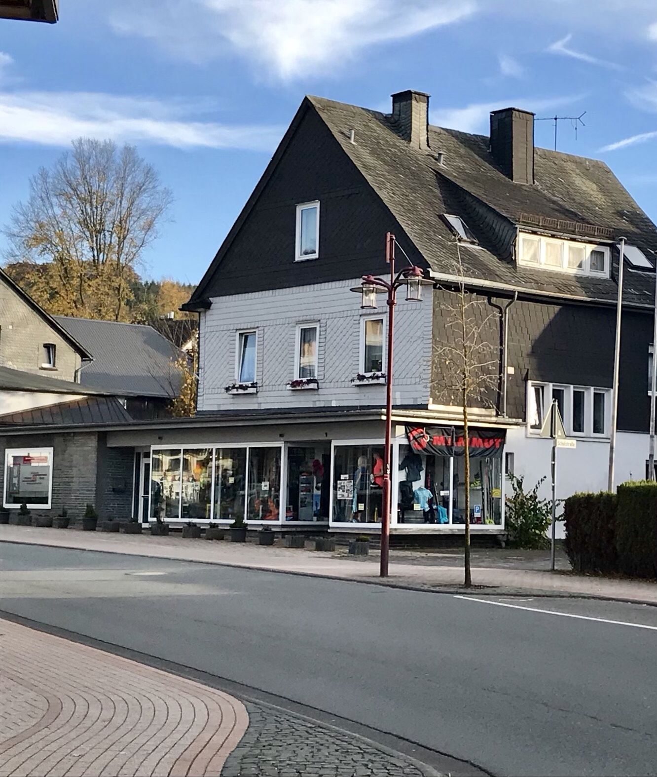 A two-story building with a storefront on the ground floor.