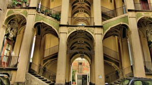 A multi-story building with ornate architectural details, including arches and balconies. - Donna Lena Relais (Naples)