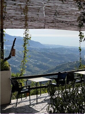 An outdoor seating area with a view of a valley.