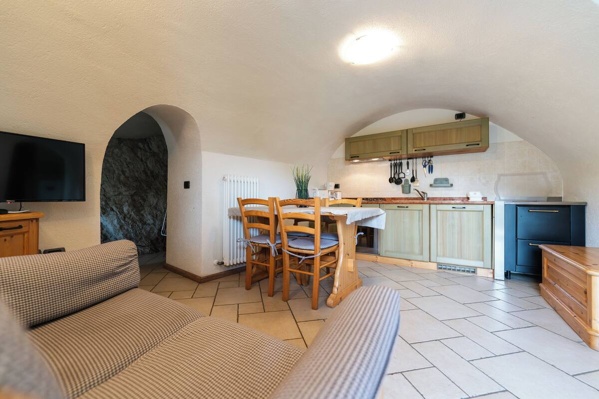 Um espaço compacto com área de jantar, cozinha e espaço para sentar.