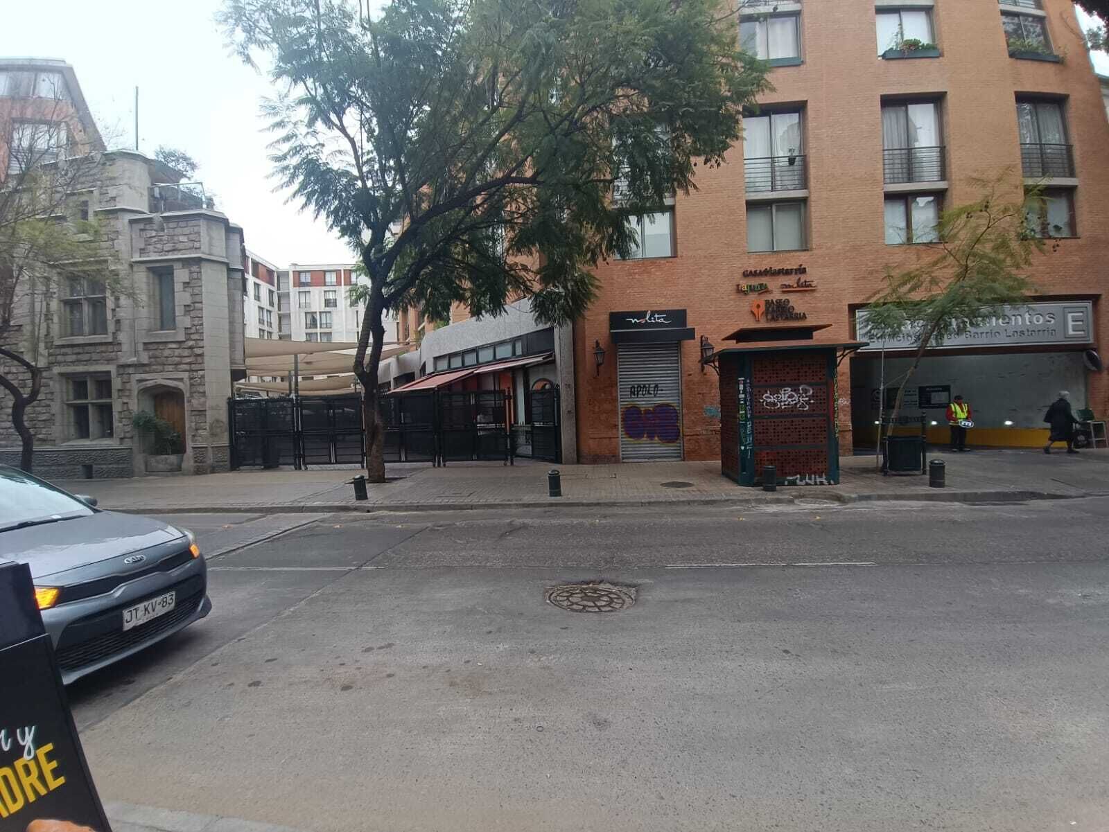 A street view with a building featuring a closed shop with a sign that reads 'APOLLO.'