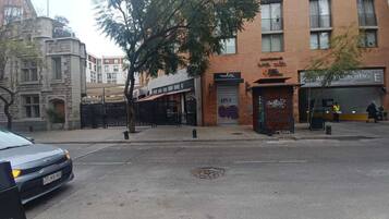 A street view with a building featuring a closed shop with a sign that reads 'APOLLO.'