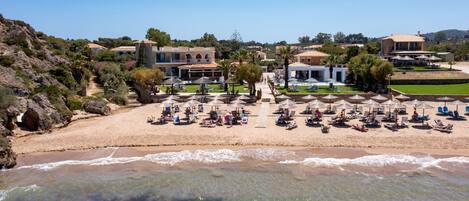 On the beach, sun-loungers, beach umbrellas, beach bar