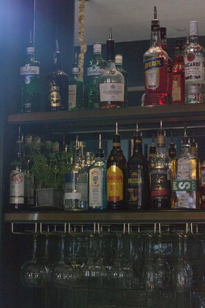 A bar area with various liquor bottles and glasses.