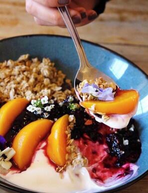 A plate with granola, yogurt, and fruit. - The Great Western Hotel (Taunton)