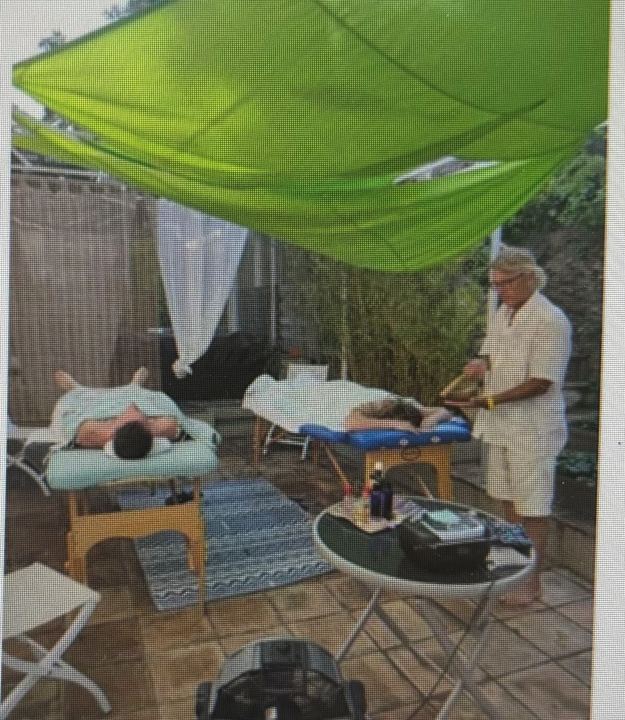 A room with a bed, a small table, and a chair.
