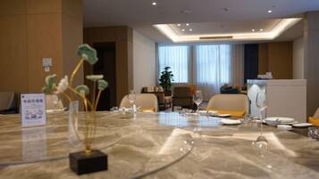 A conference room with a marble table, chairs, and a sign.
