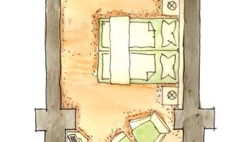 A floor plan of a house with a kitchen, dining area, and a small outdoor seating area with a table and chairs.