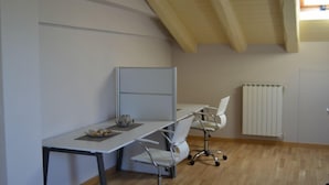 A conference room with a white table, two white chairs, a whiteboard, and a radiator. - B&B Jolie Center (Pescara)