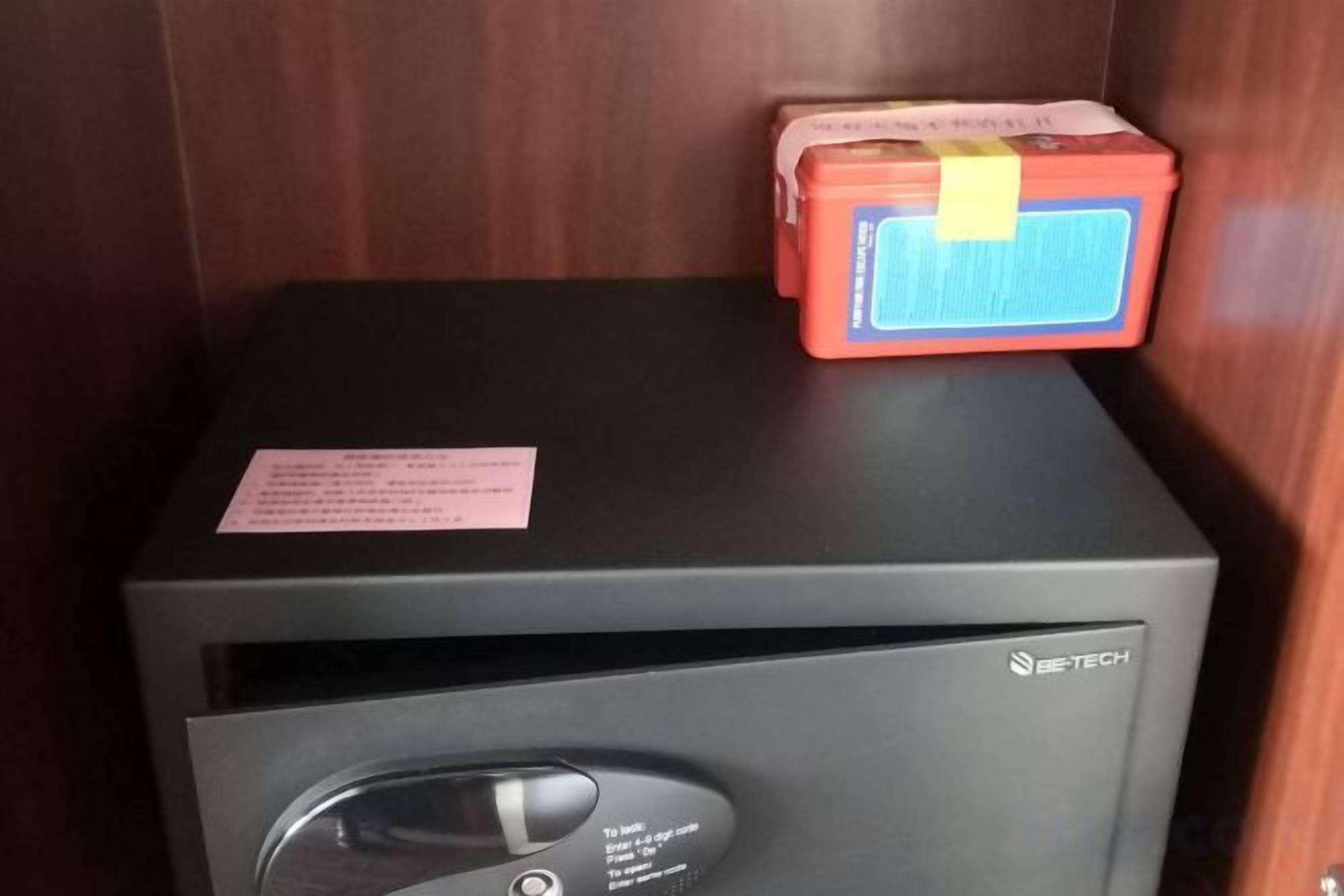 A room with a black cabinet and a red box on top.