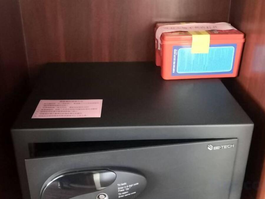 A room with a black cabinet and a red box on top.