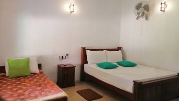 A bedroom with a bed, bedside table, and a nightstand.