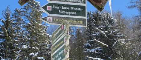 A directional signpost with multiple arrows pointing to various destinations.