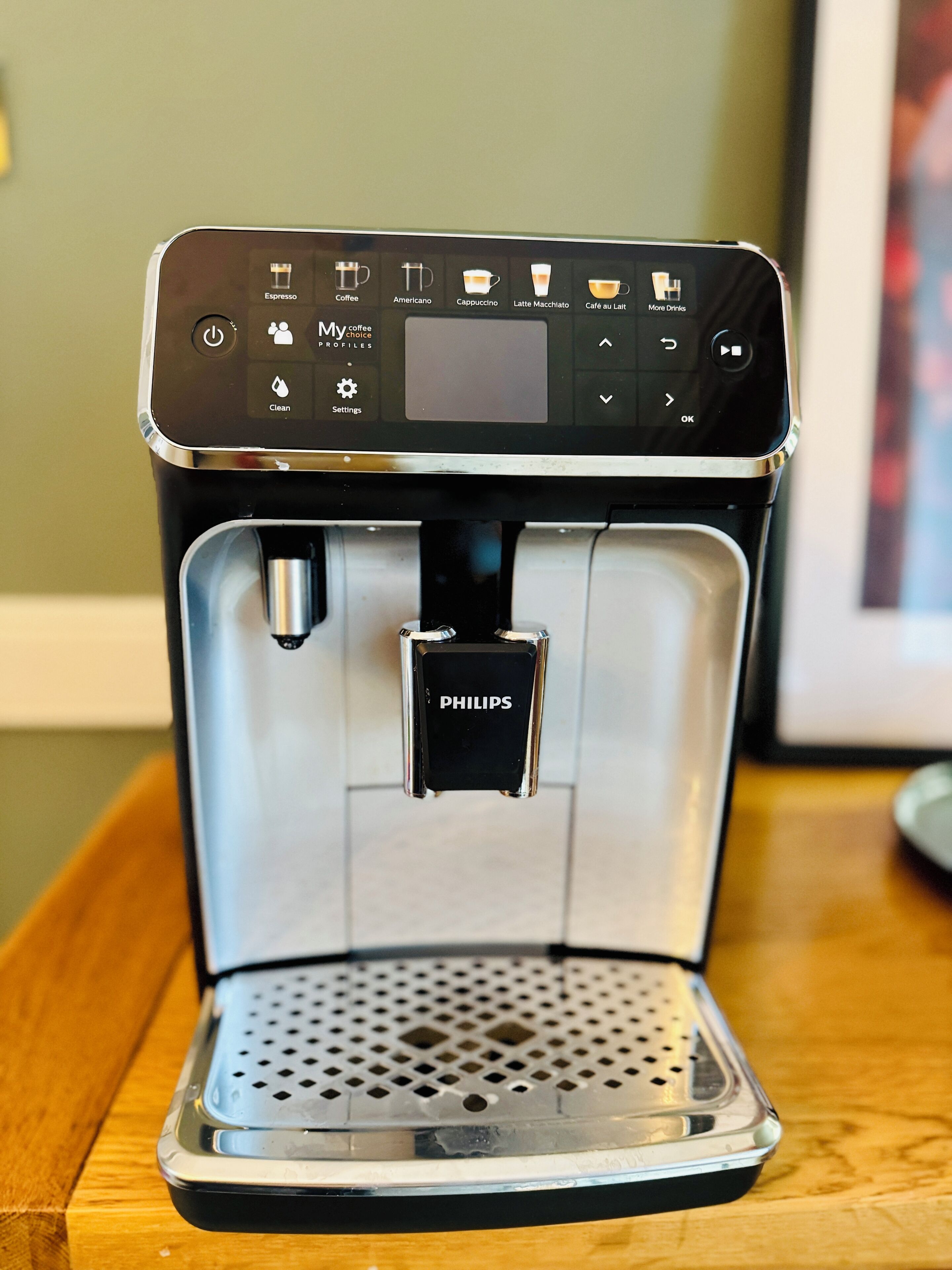 A coffee machine with a digital interface and a water reservoir.