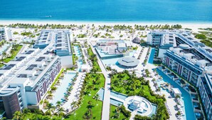 A resort with multiple swimming pools, a beach, and ocean views. - Majestic Elegance Costa Mujeres – All Inclusive (Costa Mujeres)