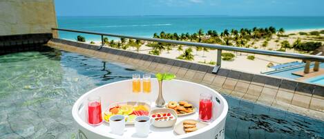 A poolside setting at Majestic Resort with a clear view of the beach and ocean.