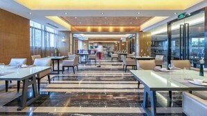 A modern hotel lobby with a marble floor, multiple seating areas, and large windows. - 3b Hotel (Yuyao Shengshan) (Yuyao)