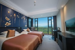 A hotel room with two beds, a TV, and a balcony with a city view. - Victoria Royal Hotel (Shangrao)