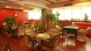 A lobby with wicker furniture, a billiards table, and potted plants. - Hongyang Hotel (Chongqing)