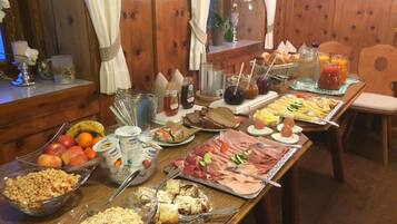 A buffet table with various food items and condiments.