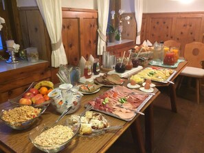 A buffet table with various food items and condiments.