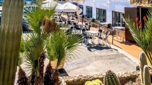 A multi-story building with a cafe named "El Fogón" on the ground floor. - Hostal Sorbas (Sorbas)