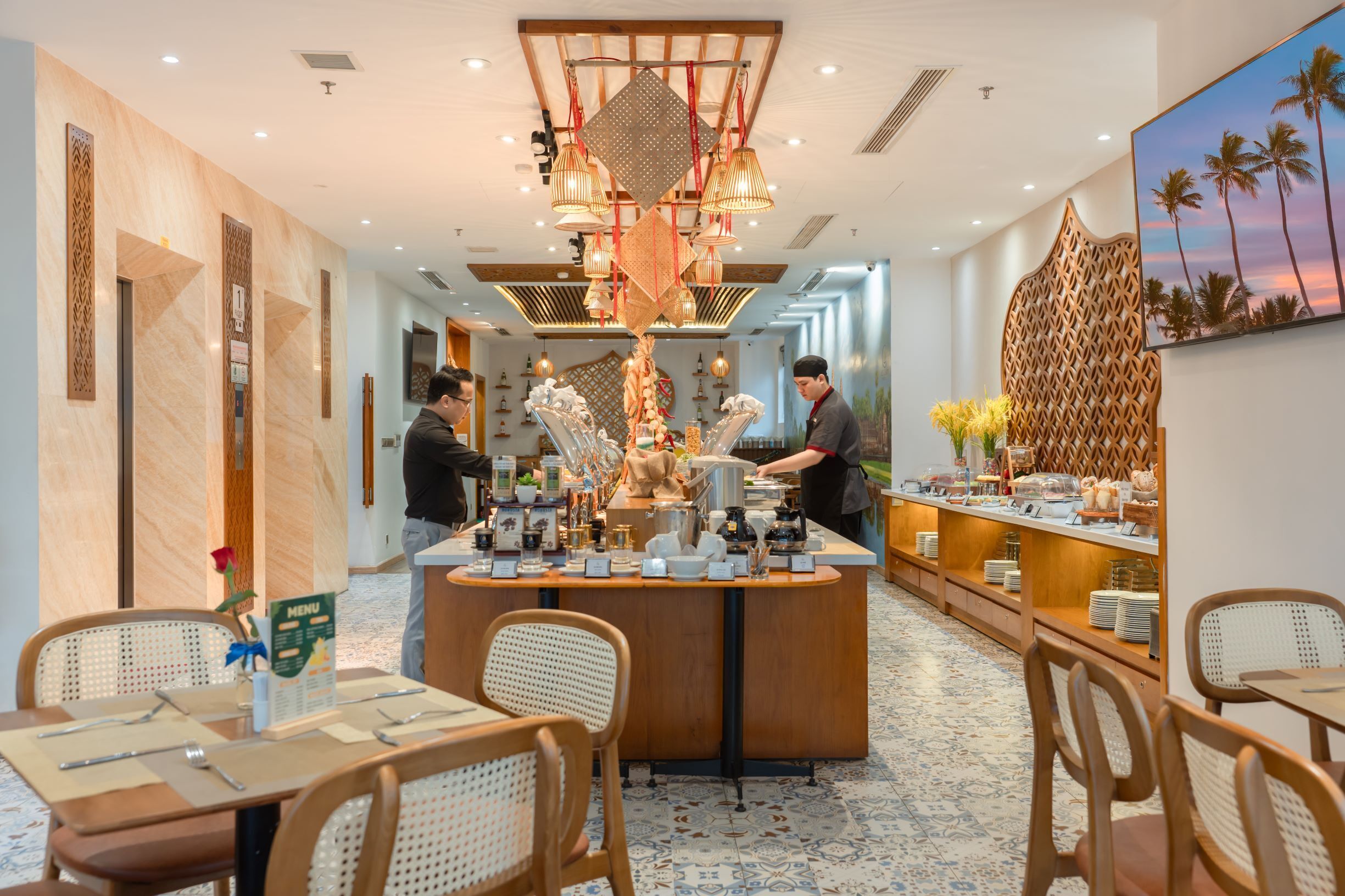 A hotel lobby with a central bar area, seating arrangements, and a decorative wall with a palm tree painting.