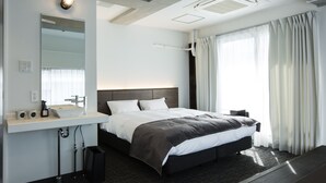 A modern hotel room with a large bed, a built-in sink, and a large window with curtains. - UNPLAN Shinjuku – Hostel (Tokyo)