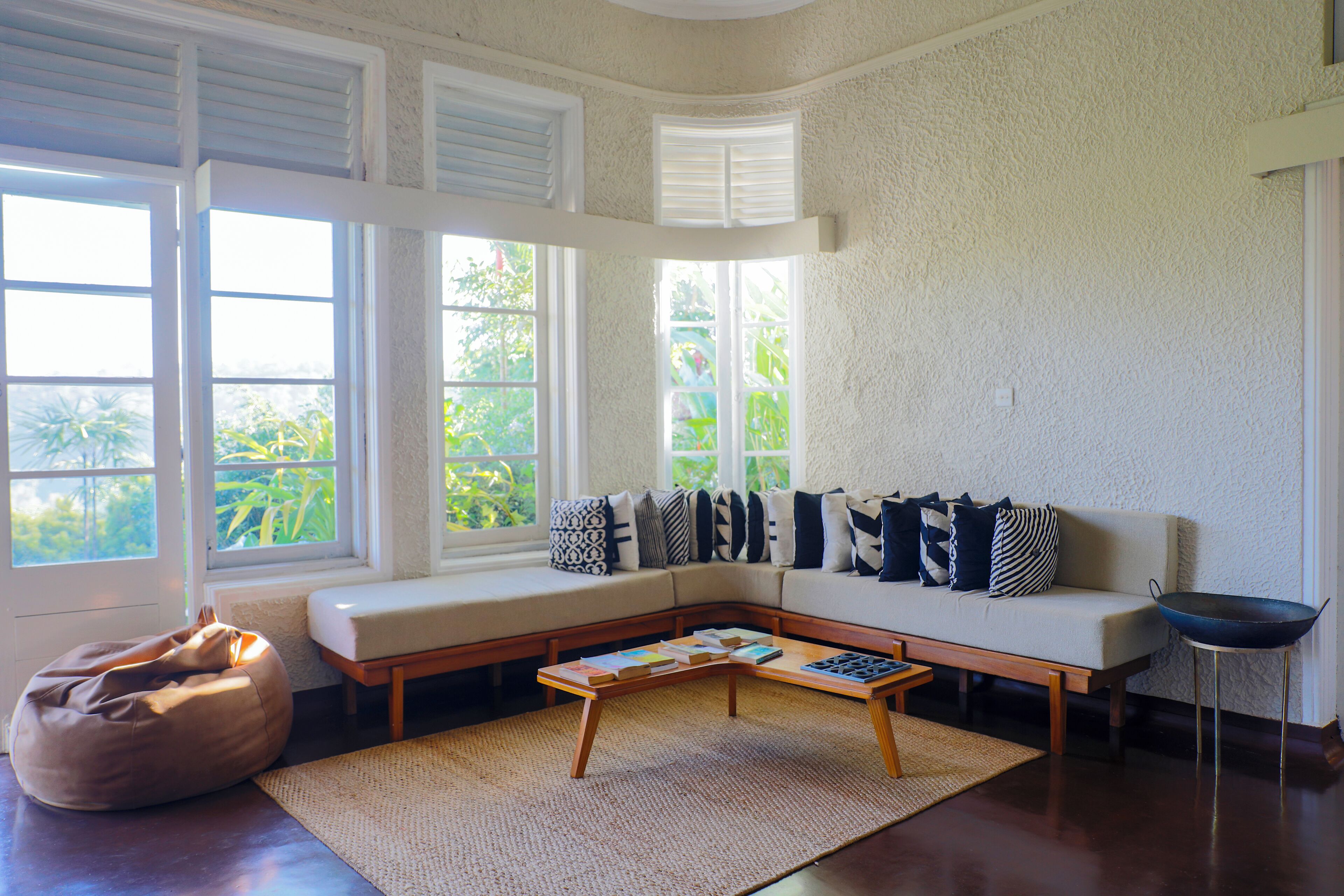 A living room with a sofa, bean bag, and coffee table.