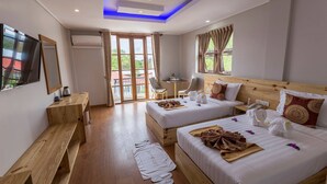 A hotel room with two beds, a wooden bench, a desk, a TV, and a balcony with a view. - Hotel Mya Yar Pin (Kalaw)